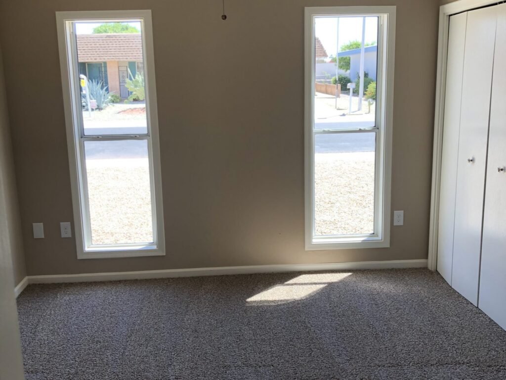 Empty bedroom with new grey carpet