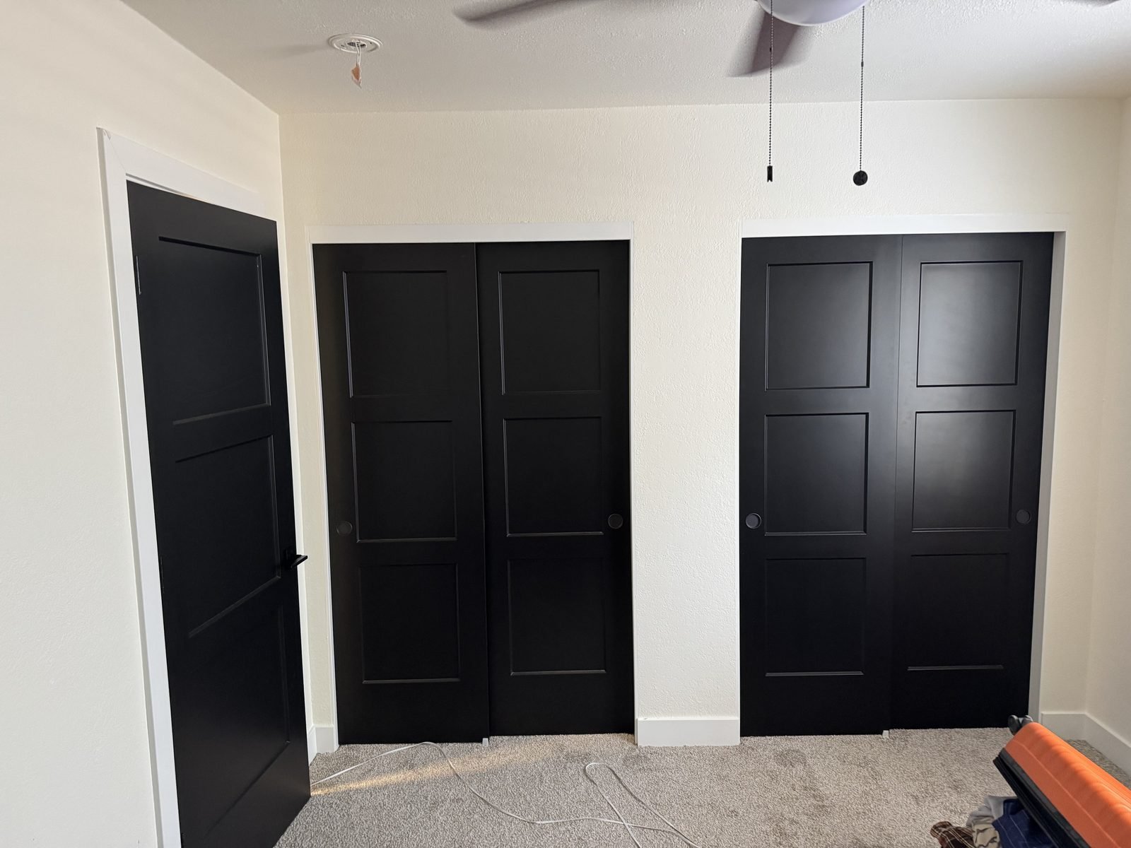 Black shaker closet and entry doors newly hung