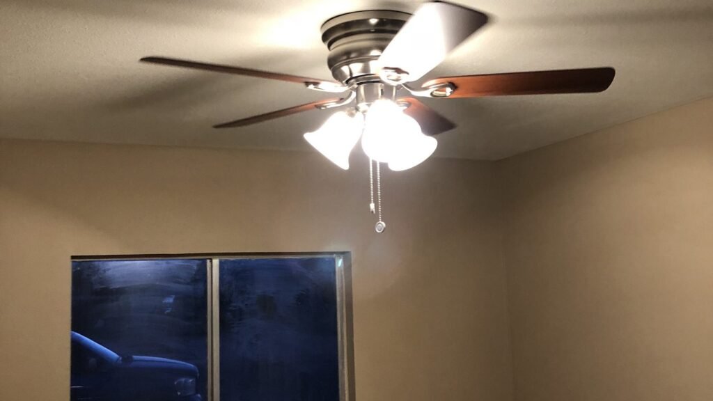 Ceiling fan with light kit installed in a bedroom