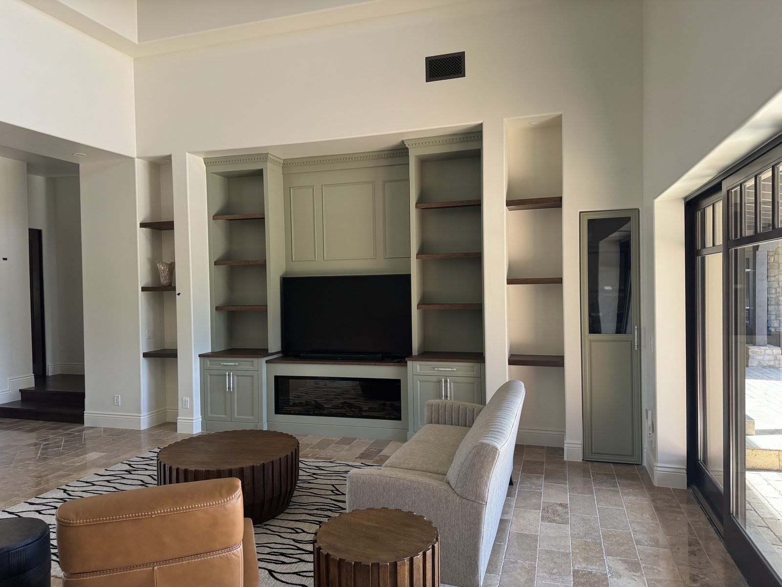 Custom built-in entertainment wall with open shelving in a living room