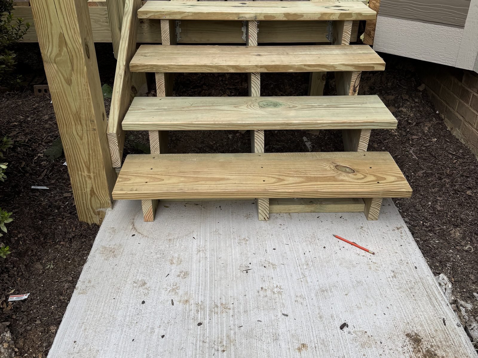 New deck stairs built onto a fresh concrete landing
