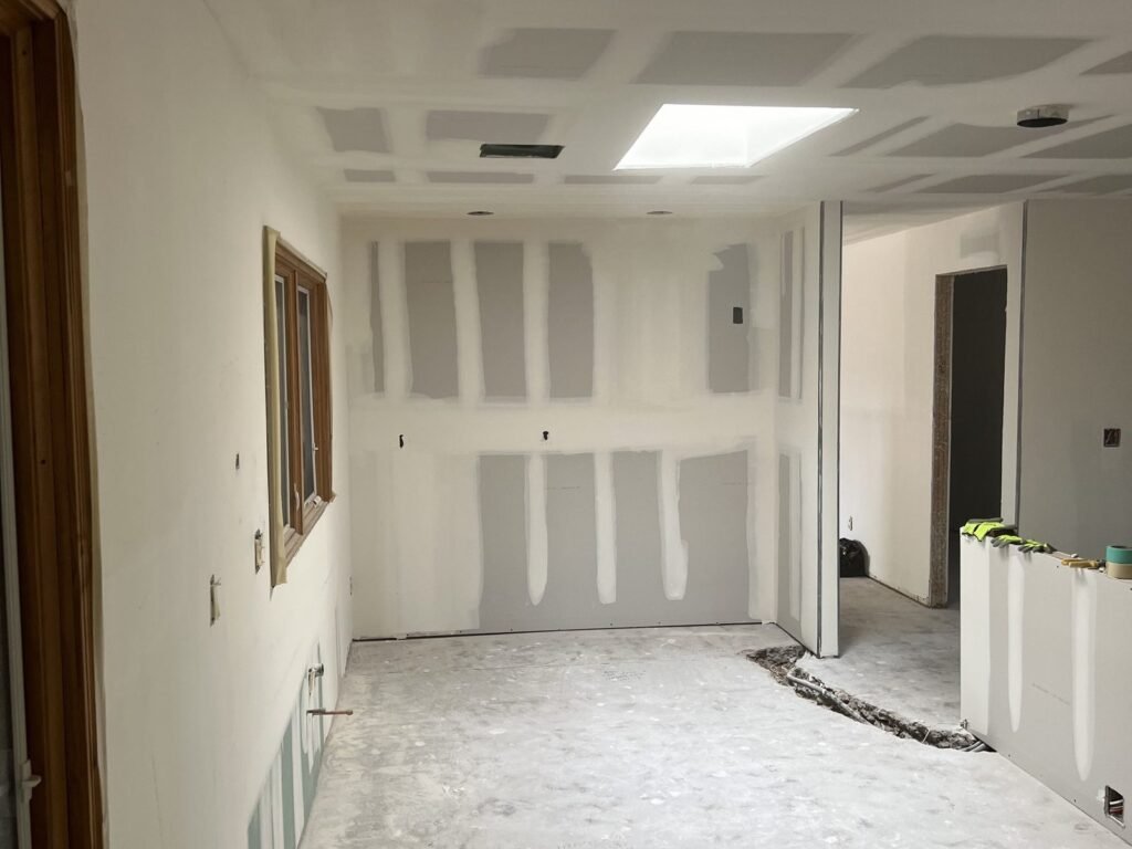 New drywall hung on kitchen walls ready for finishing