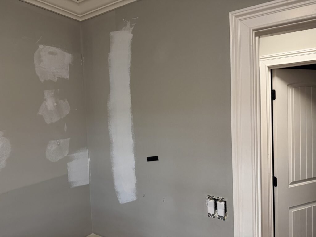 Interior wall with drywall patches ready for paint