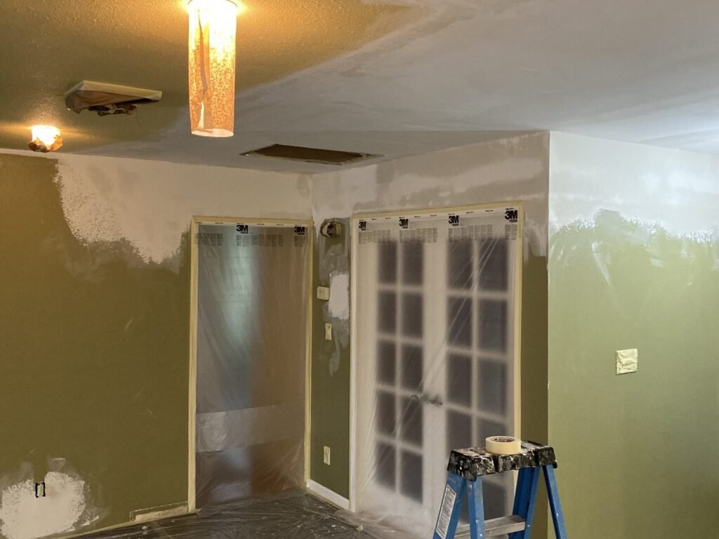Room with repaired walls and protected flooring during works