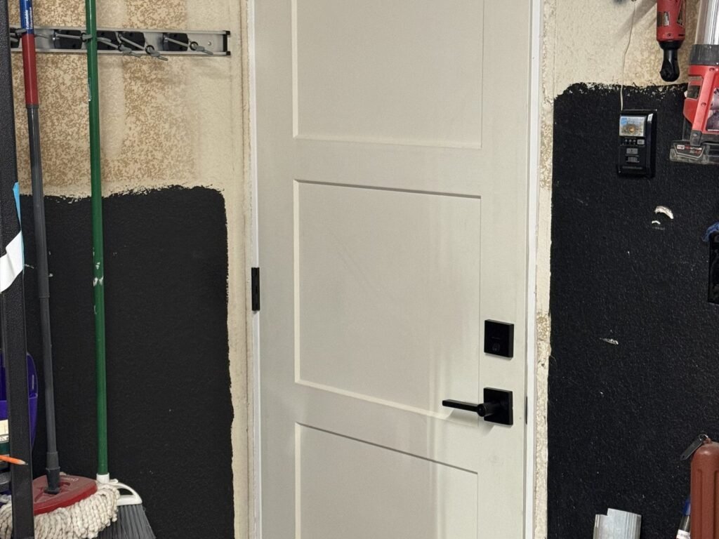 New panel door hung with black lever hardware