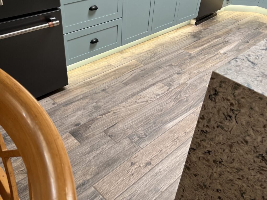Kitchen floor part-way through a plank flooring installation