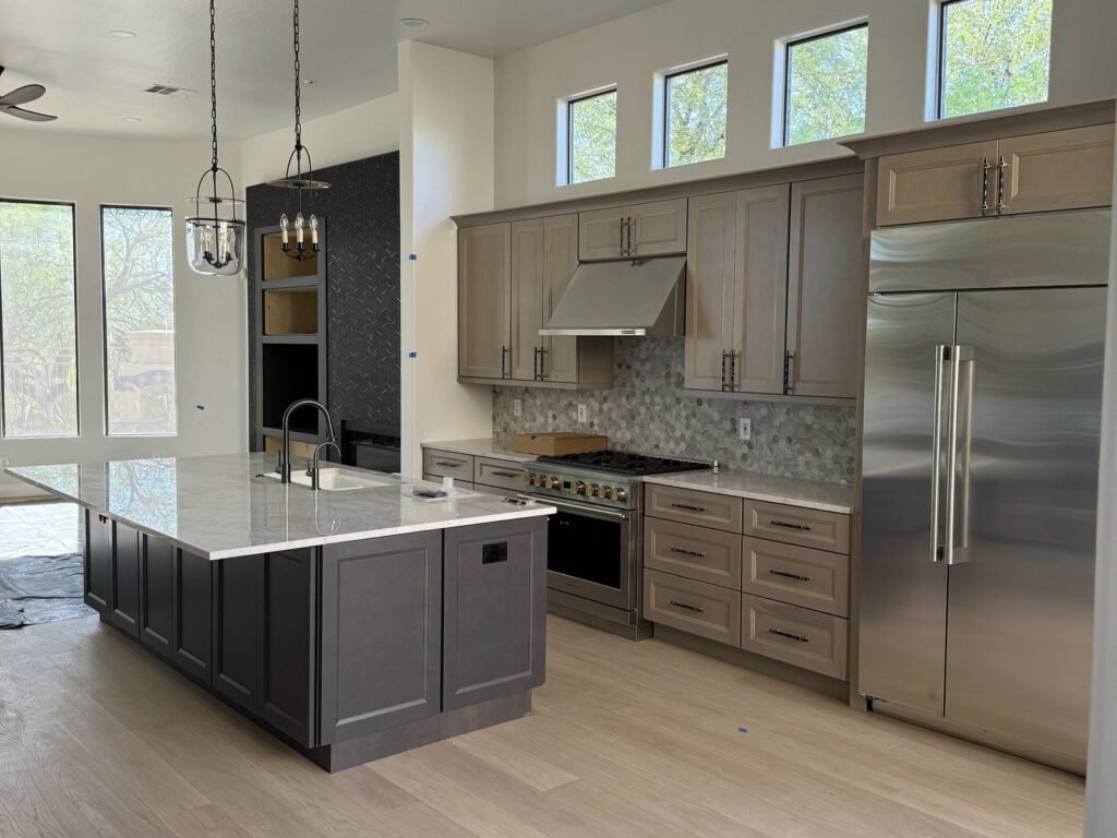 Kitchen with long island, stainless appliances and tiled backsplash