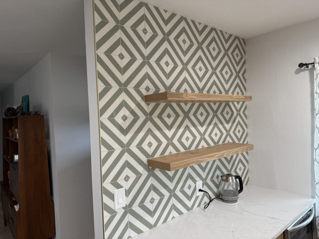 Floating wood shelves on a patterned accent wall