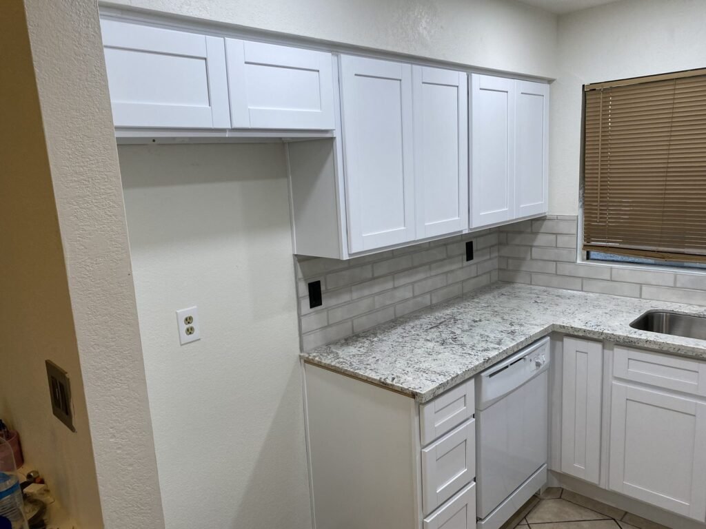 White Kitchen Cabinets with white shaker cabinetry and subway tile backsplash