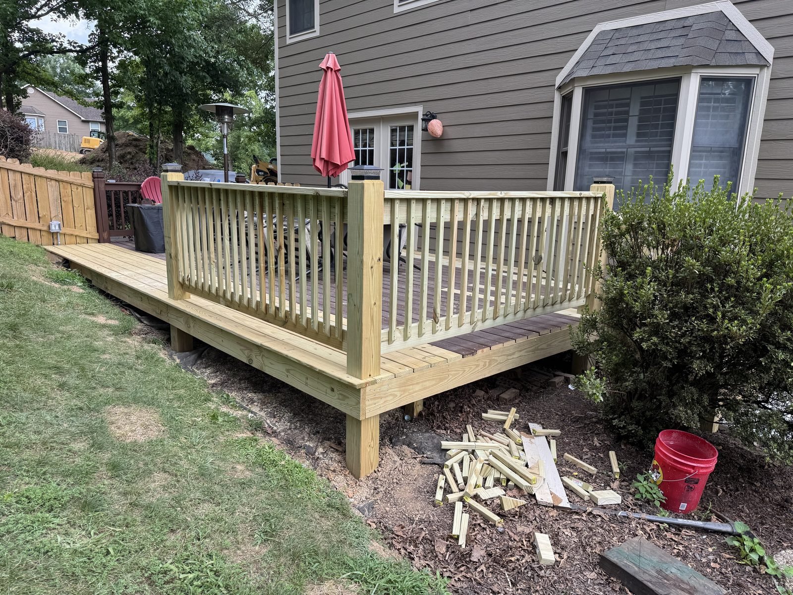 Finished rebuilt wood deck with new railing